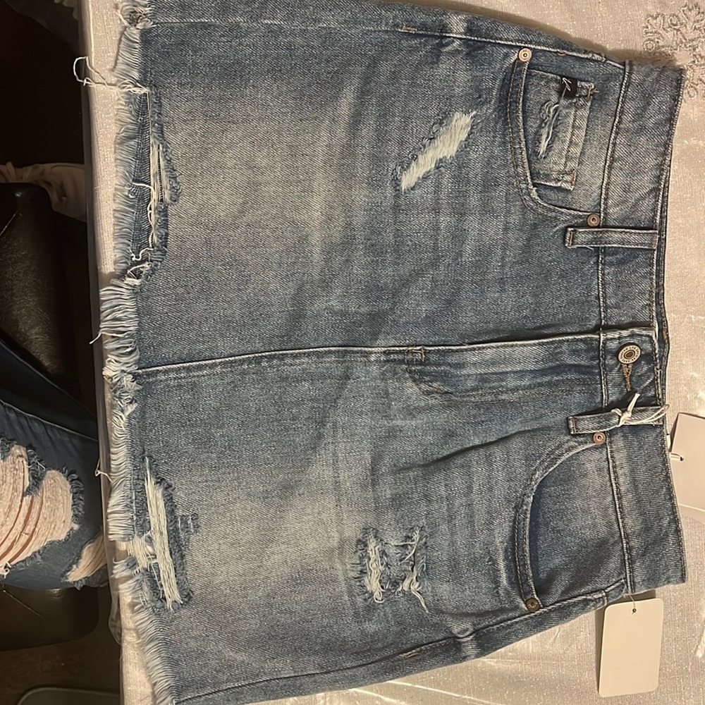 I am selling a skirt, Brand is KanCan, Size is Medium, Color is light wash.